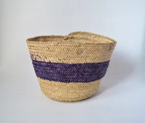 Round straw basket from natural palm leaves with a wide Purple stripe